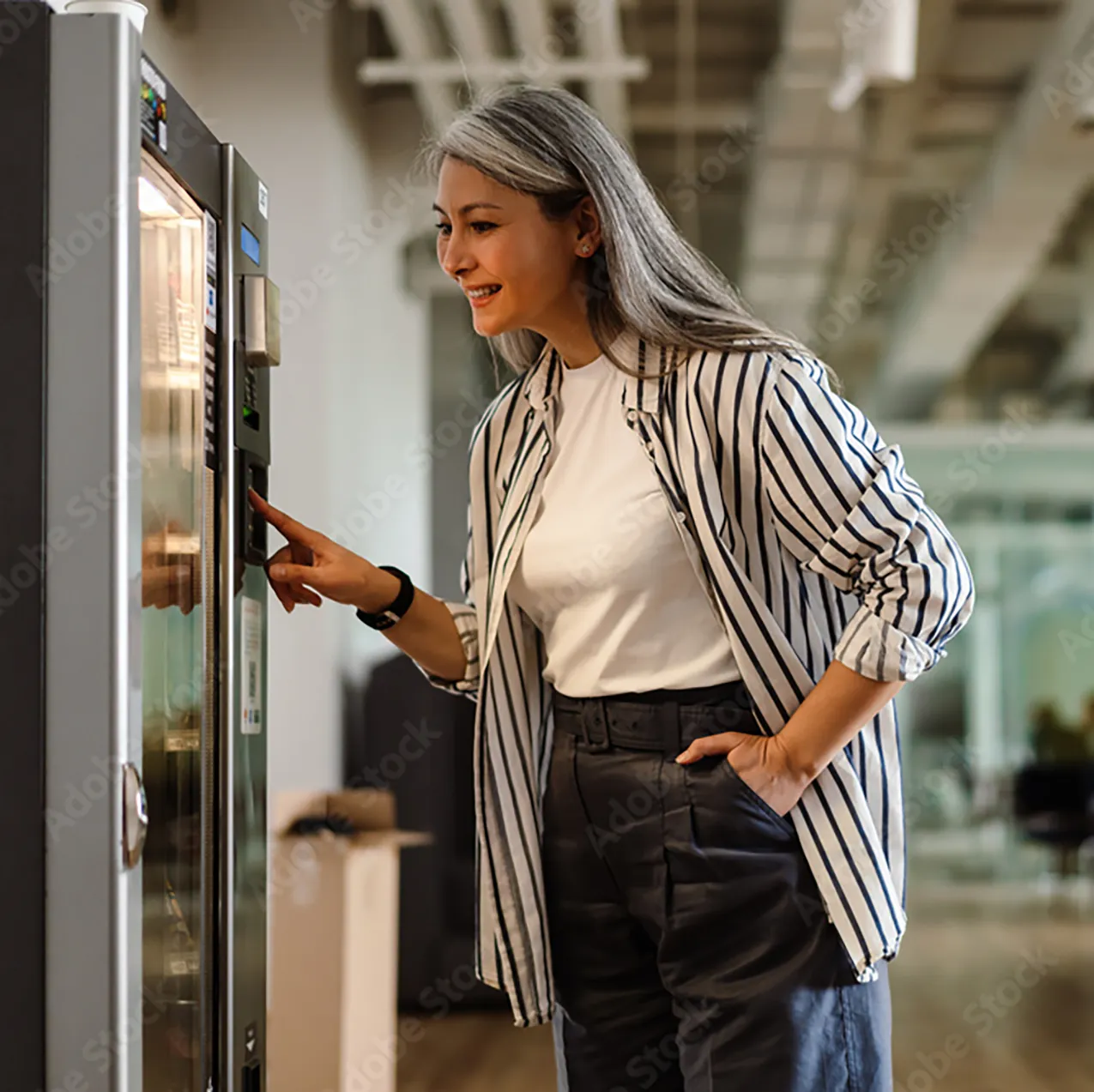 Woman selecting items from a vending machine